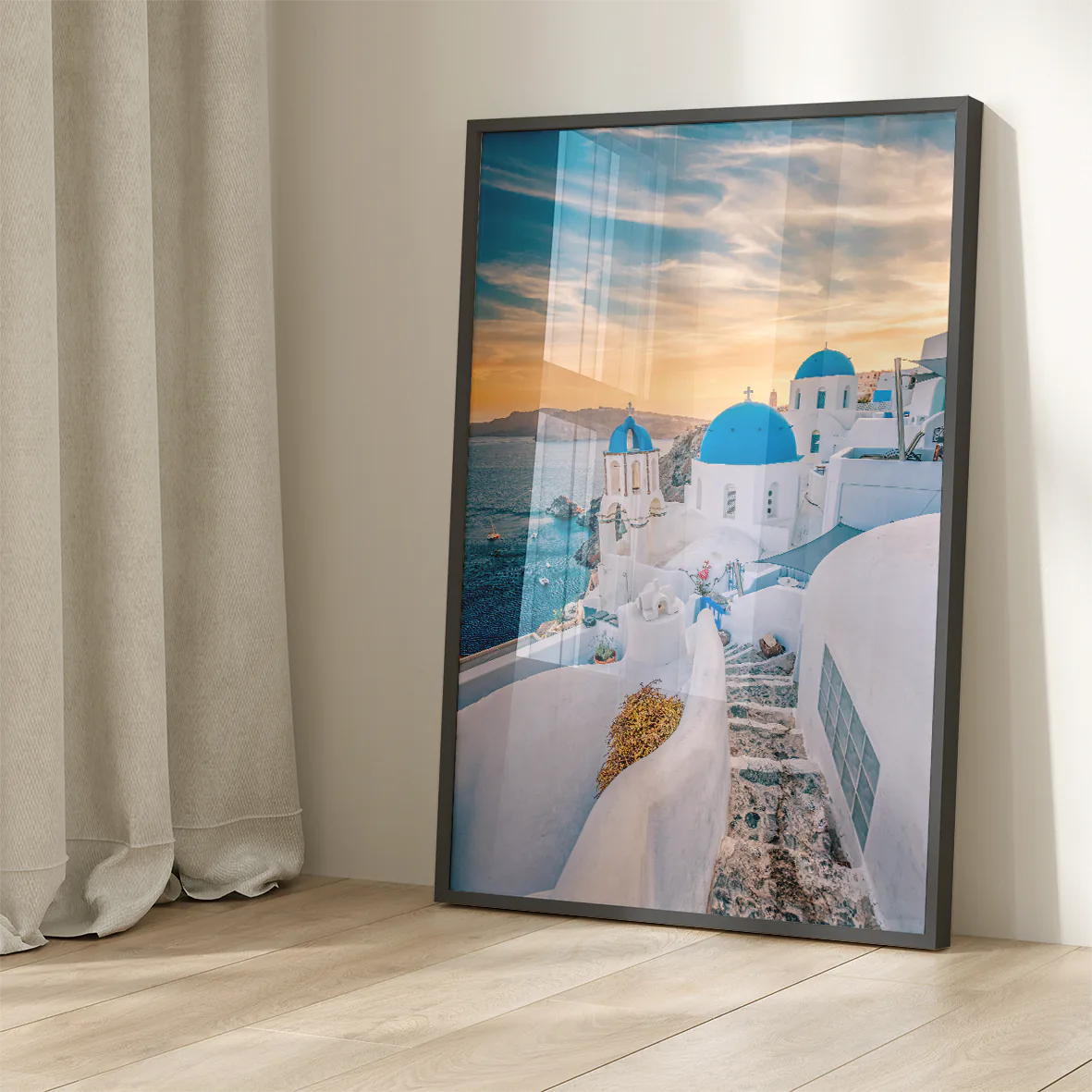 Wall art capturing the beauty of Santorini's sunset with blue domes and whitewashed buildings against a pastel sky