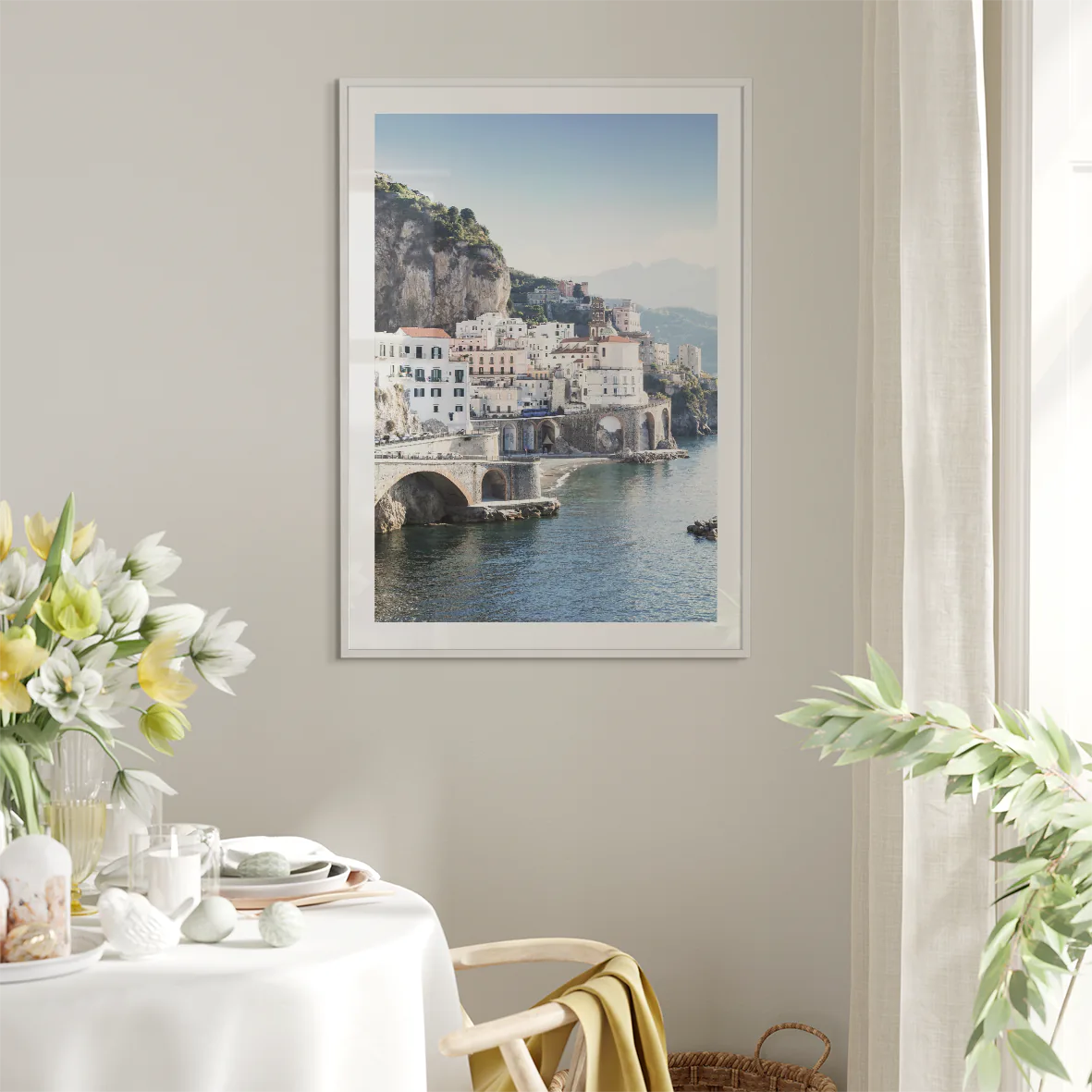 Wall art of a Mediterranean coastal town with historic white buildings and sea arches in daylight