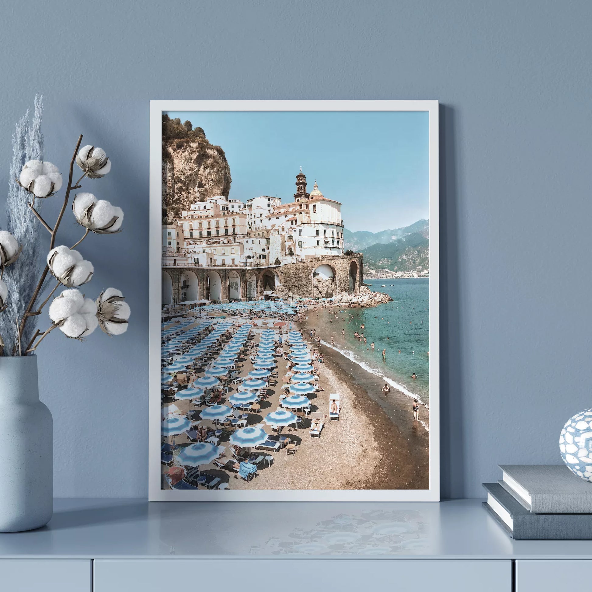 アマルフィ海岸の白壁建築と青いパラソルが並ぶビーチ風景