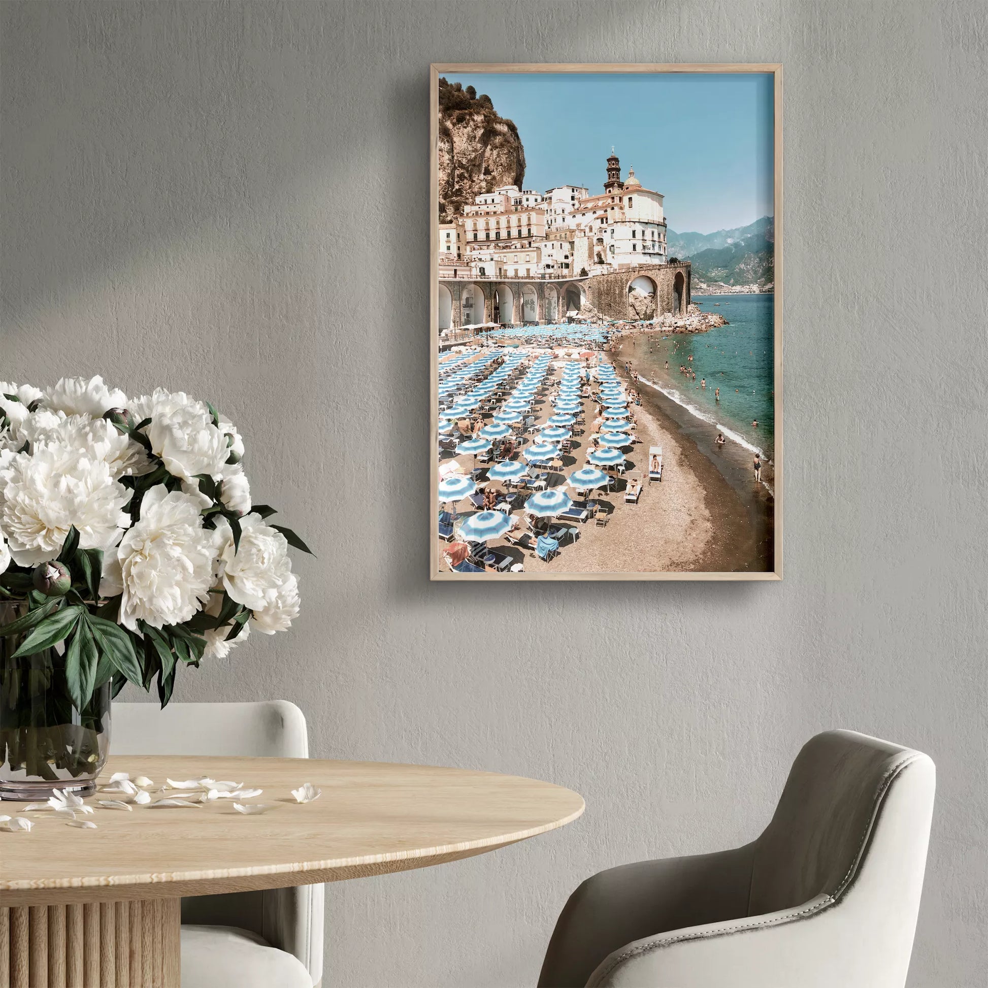 アマルフィ海岸の白壁建築と青いパラソルが並ぶビーチ風景