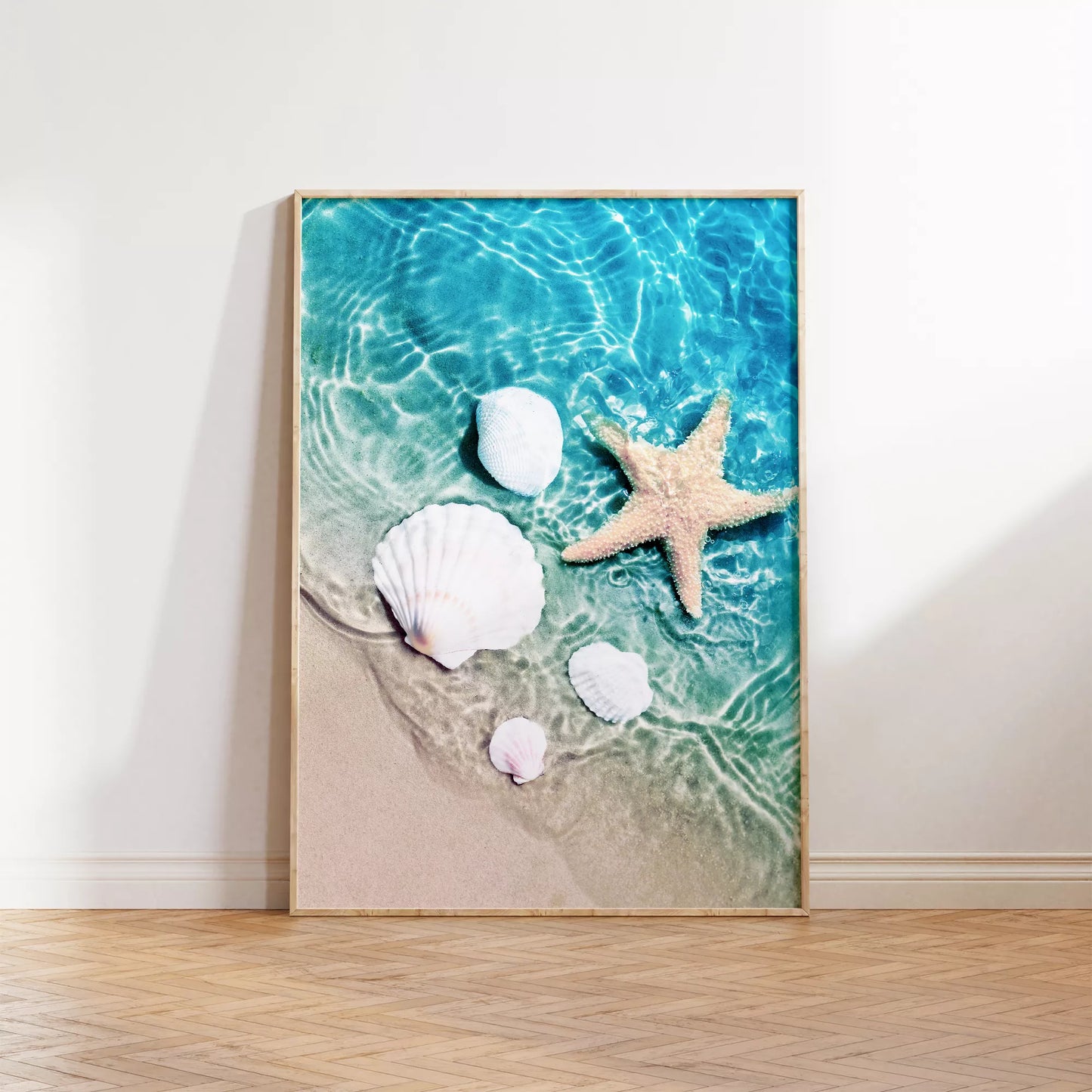 透明な青い海水とビーチに置かれた白い貝殻とヒトデのアート写真