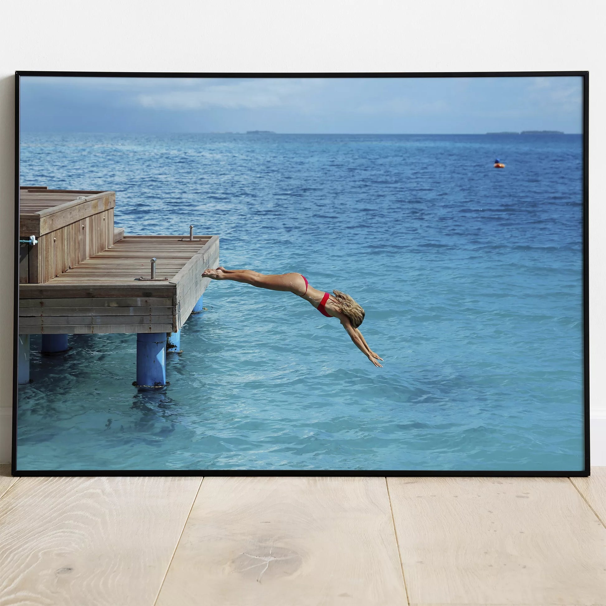 青い海に木製デッキからダイビングする爽快な瞬間