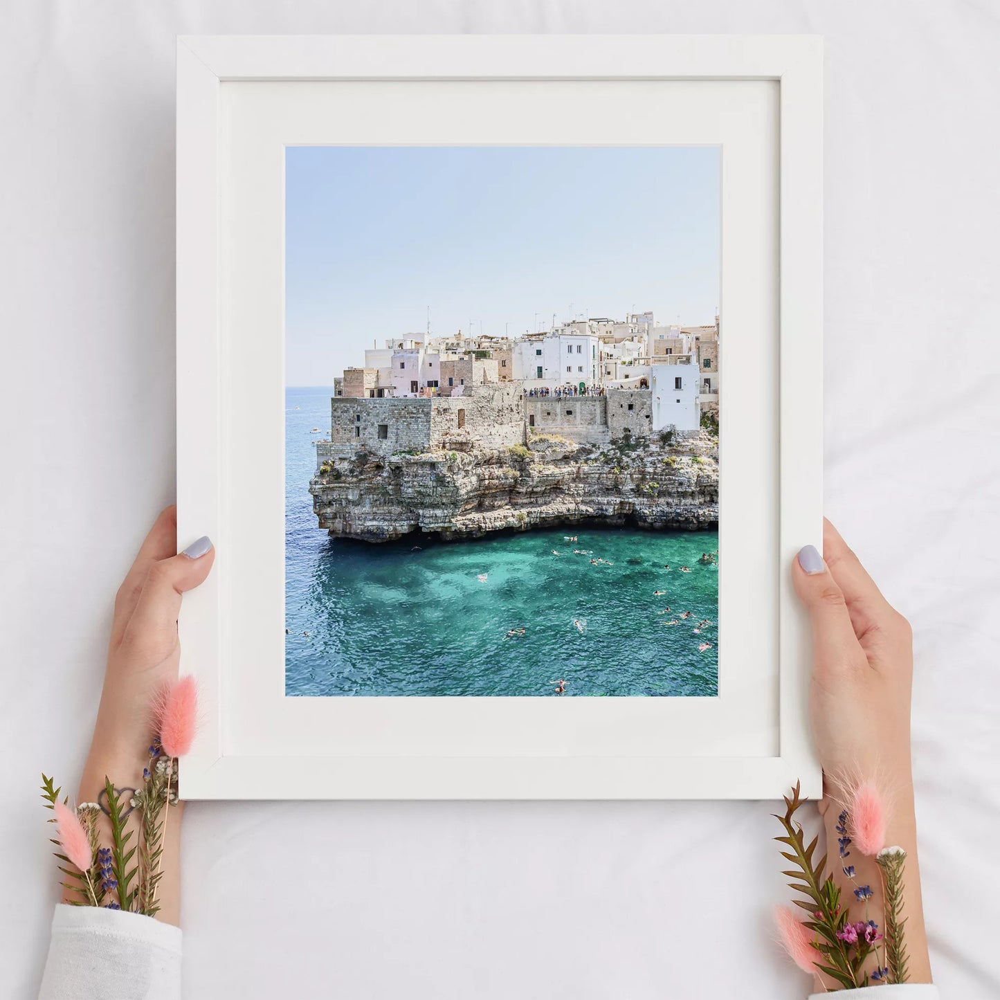 イタリア南部プーリア州の断崖絶壁に建つ白壁の街並みと青い海の風景