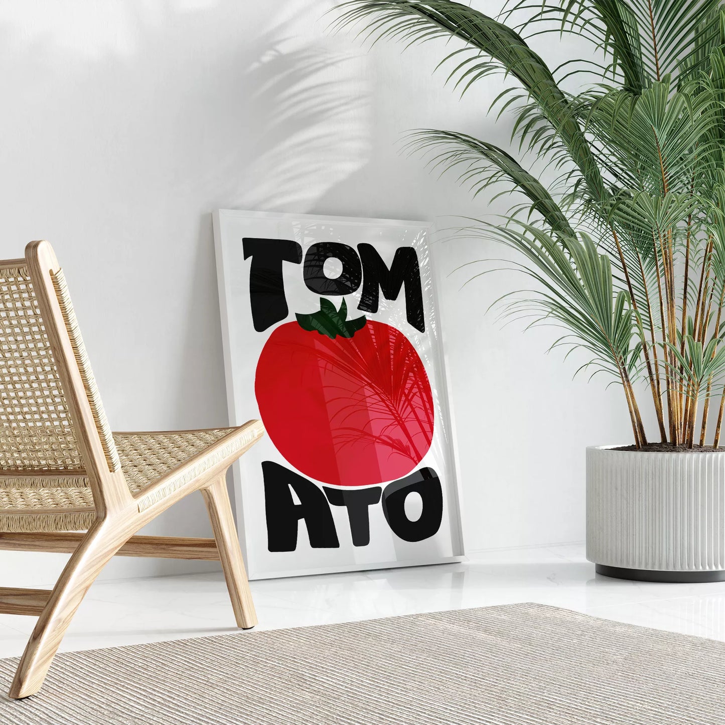 白地にモダンな黒字で「TOMATO」の文字を「TOM」と「ATO」に分け、その間に大きな赤いトマトのイラストをあしらったミニマルなアートプリント。緑の葉がアクセントとなり、シンプルながらインパクトのあるデザイン。