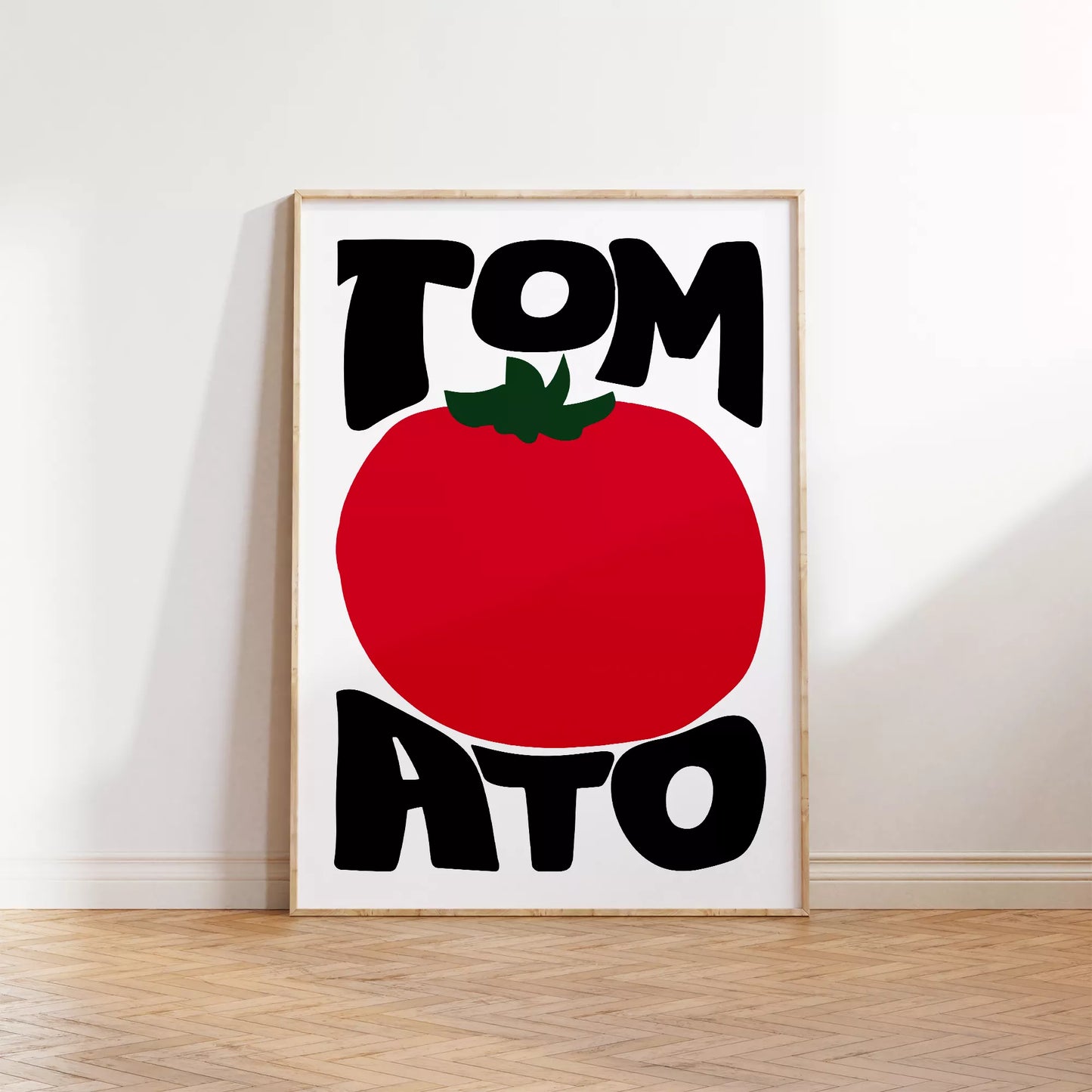 白地にモダンな黒字で「TOMATO」の文字を「TOM」と「ATO」に分け、その間に大きな赤いトマトのイラストをあしらったミニマルなアートプリント。緑の葉がアクセントとなり、シンプルながらインパクトのあるデザイン。