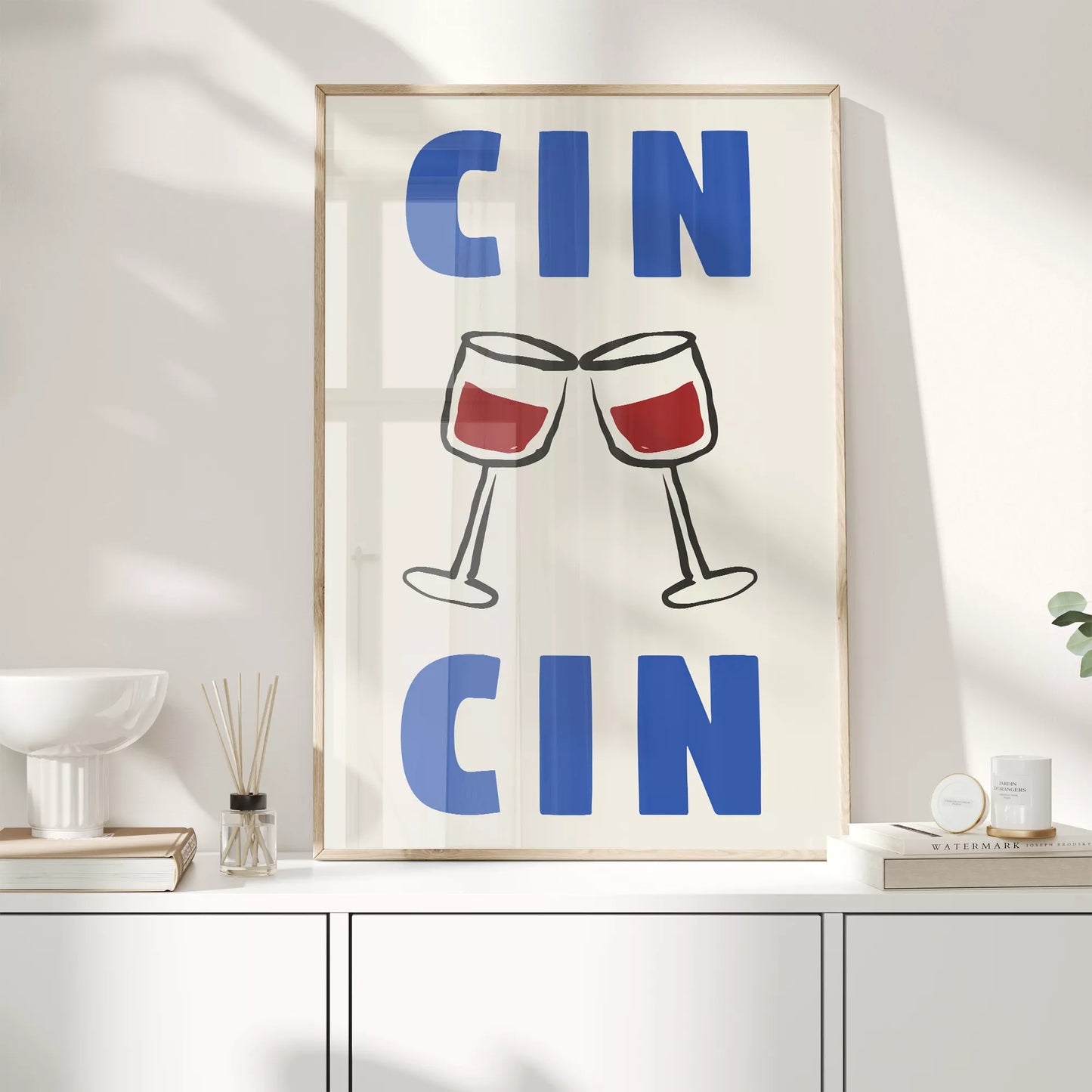 クリーム色の背景にブルーの「CIN CIN」の文字とシンプルな線画で描かれた赤ワインの乾杯グラスを配したミニマリストアートポスター
