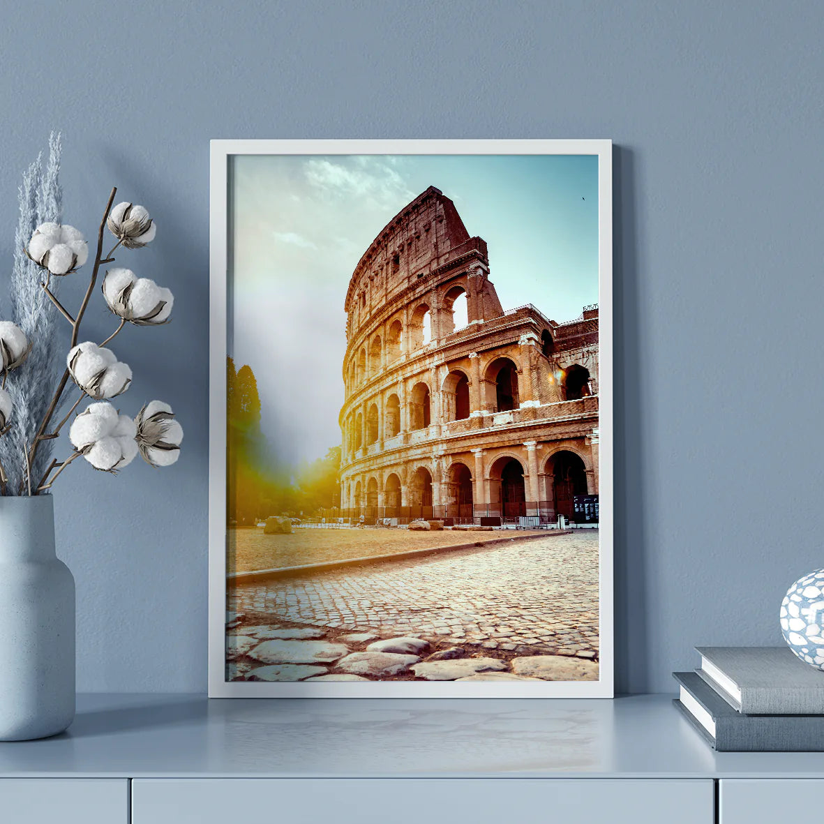 Wall art of the Colosseum in Rome with the sun rising behind it