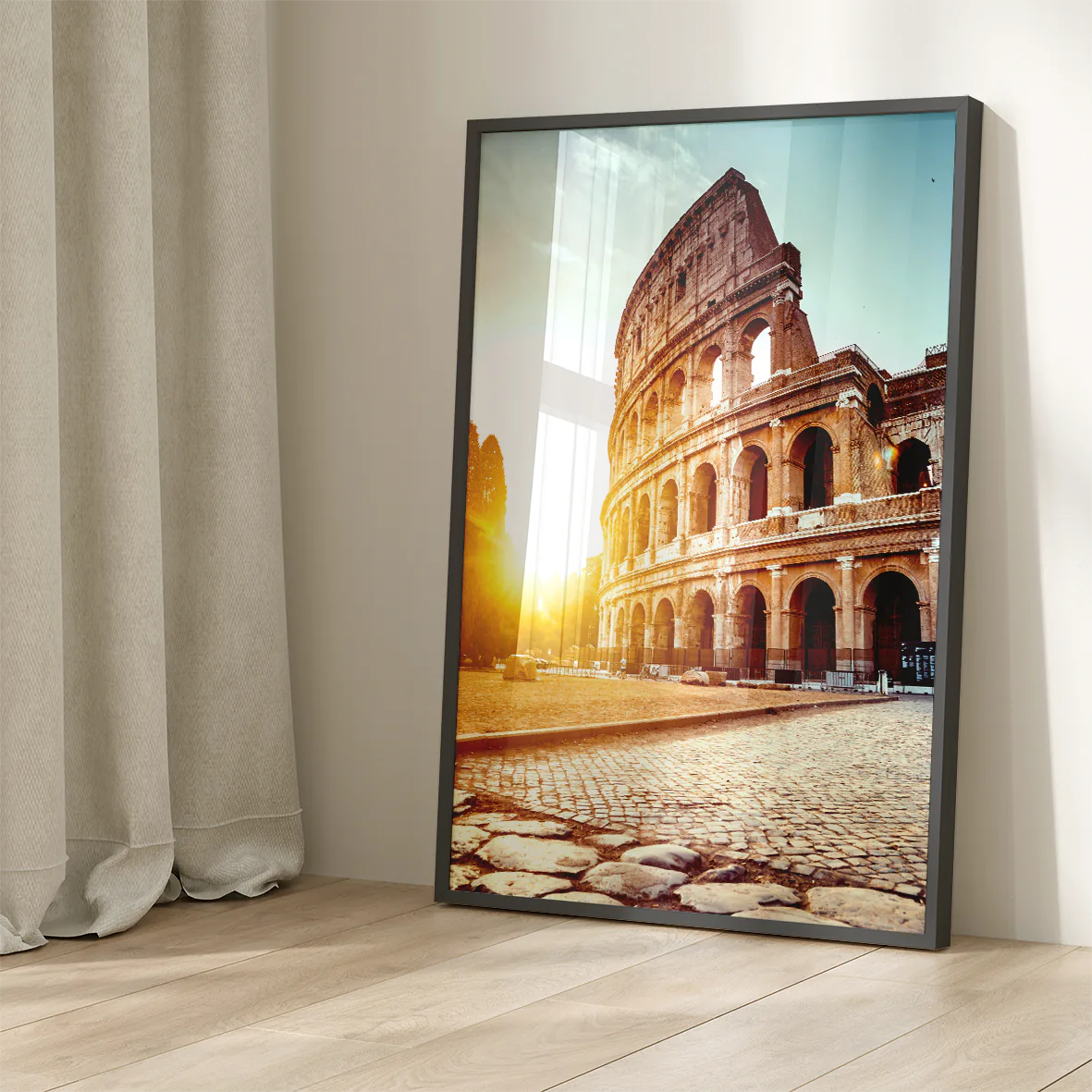 Wall art of the Colosseum in Rome with the sun rising behind it