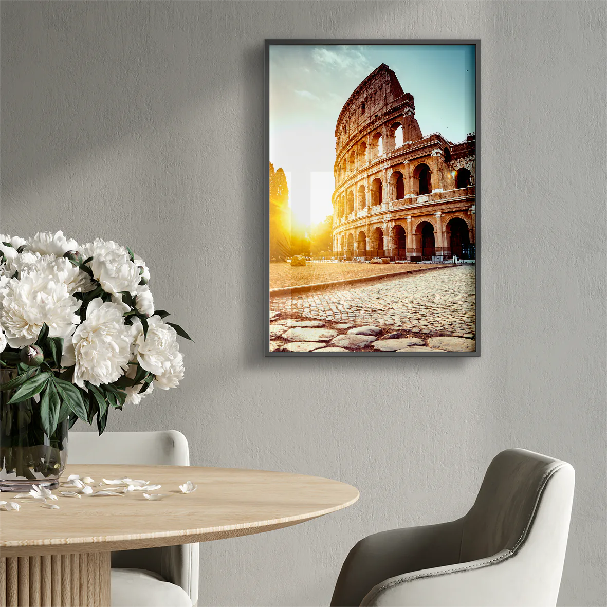 Wall art of the Colosseum in Rome with the sun rising behind it