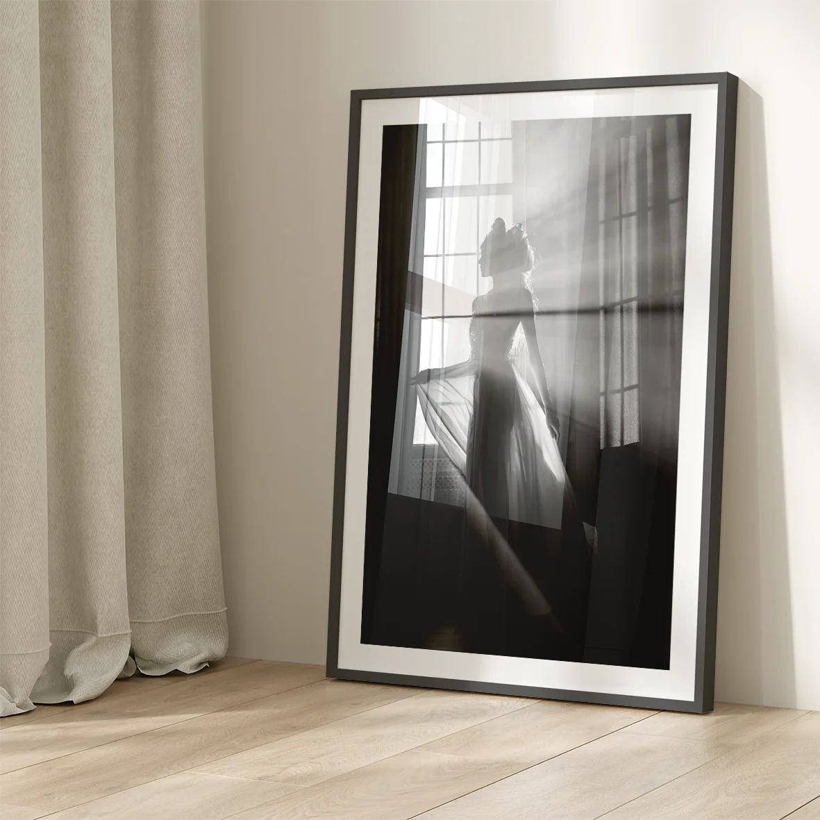 Elegant bride standing by the window, her wedding gown illuminated in the soft light