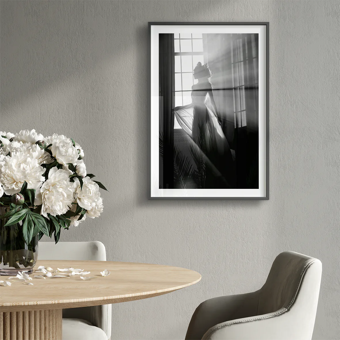 Elegant bride standing by the window, her wedding gown illuminated in the soft light