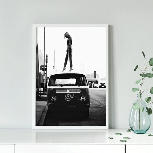 Retro-inspired wall print featuring a person atop a classic VW van