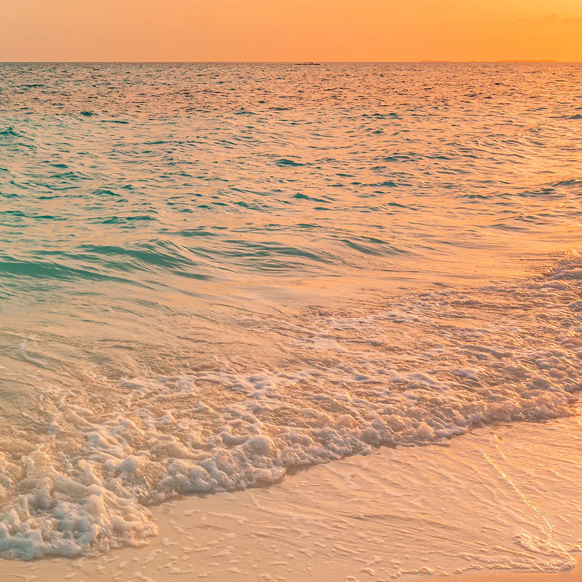 Breathtaking beach sunset wall art with the sun setting over a calm ocean, reflecting warm colors on the water.