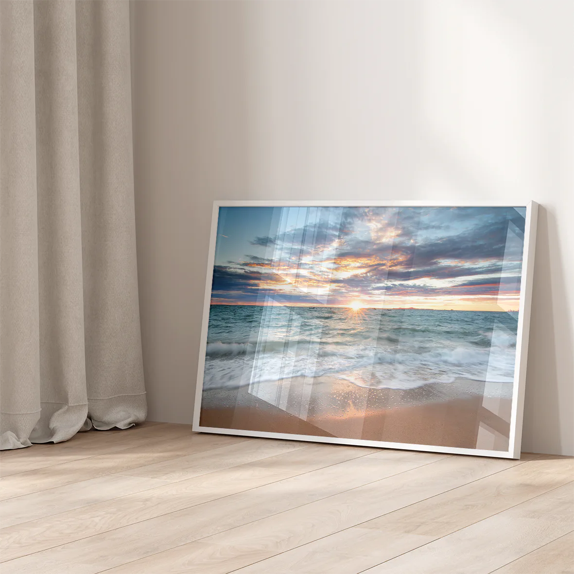 Coastal wall art of a serene sunset painting the beach sky in vibrant hues of orange and pink.