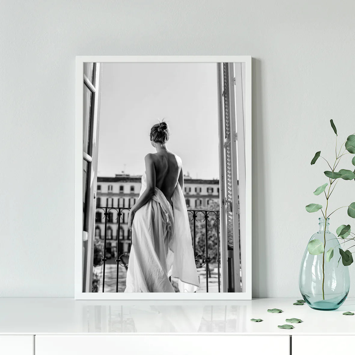 Black and white photo of woman on balcony in flowing gown