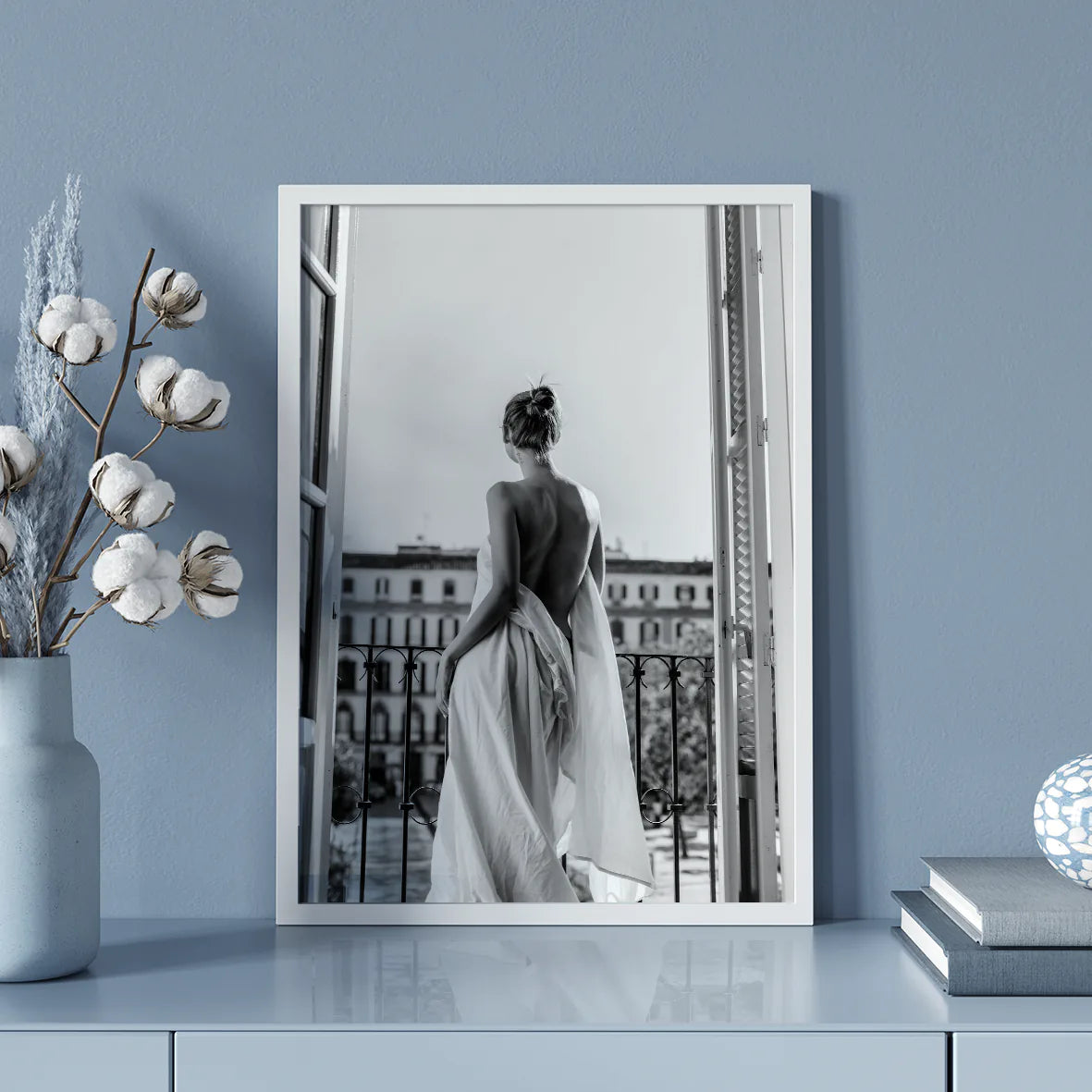 Black and white photo of woman on balcony in flowing gown