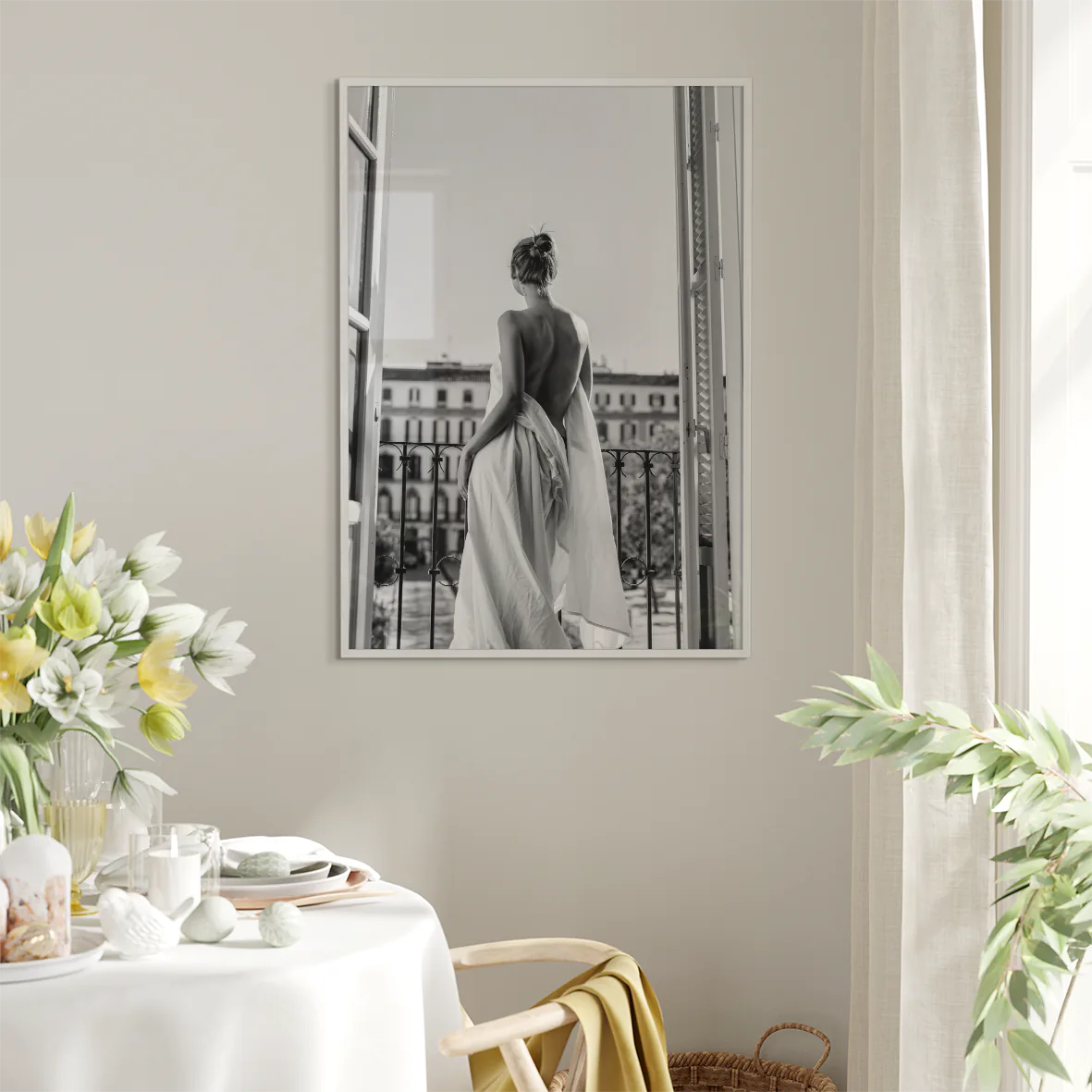 Black and white photo of woman on balcony in flowing gown