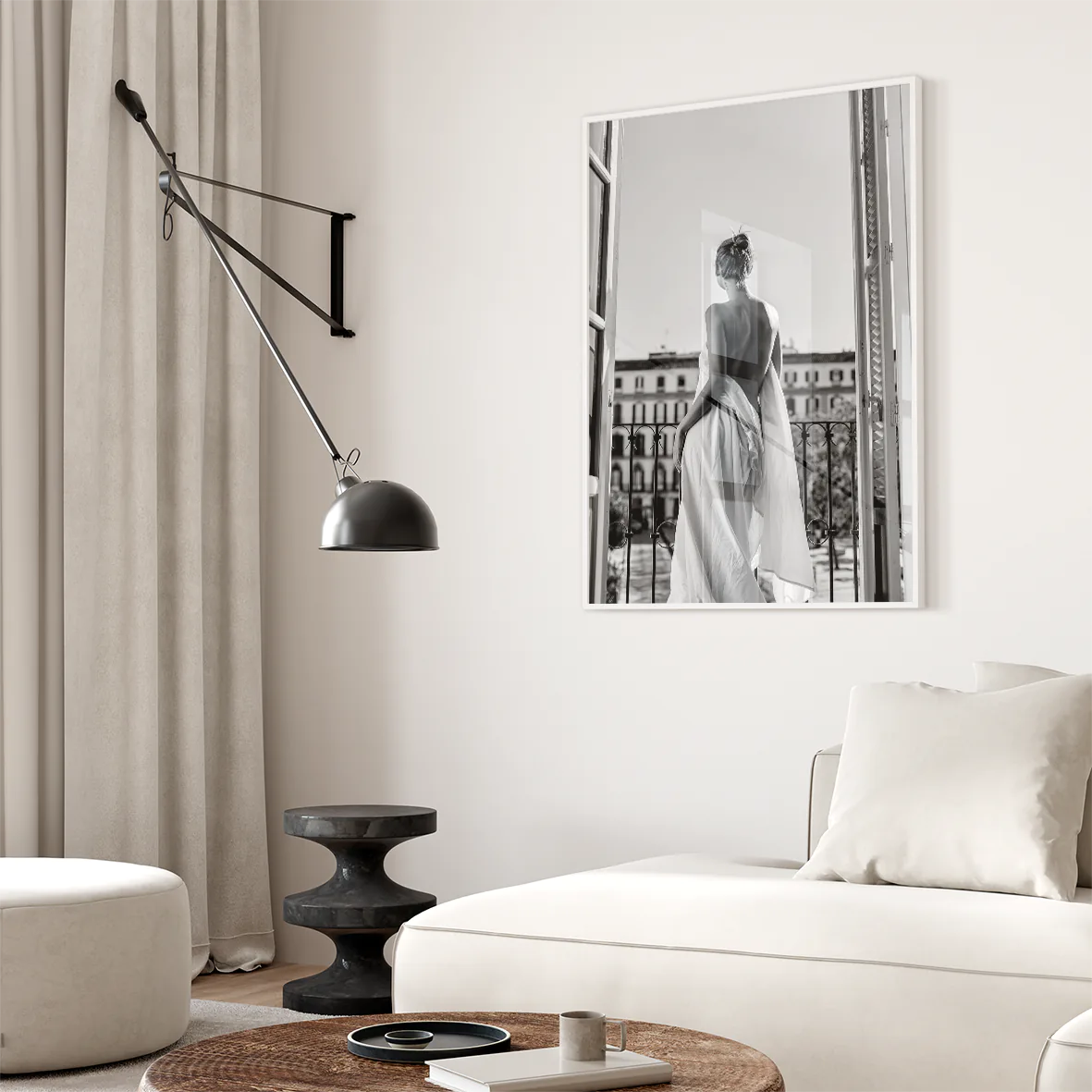 Black and white photo of woman on balcony in flowing gown