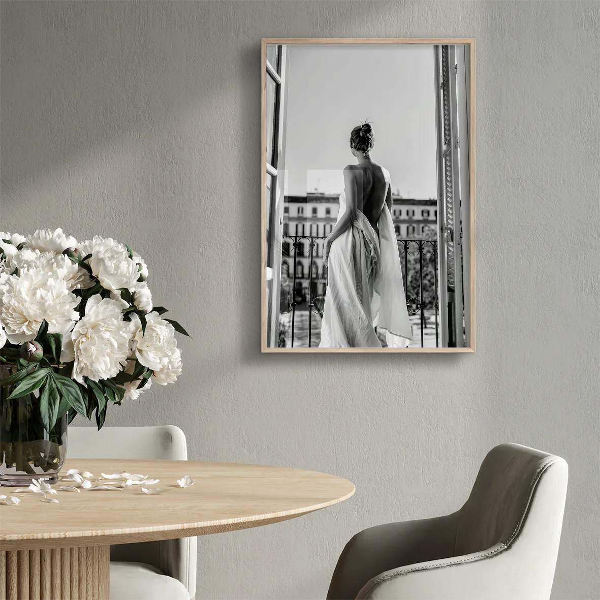 Black and white photo of woman on balcony in flowing gown