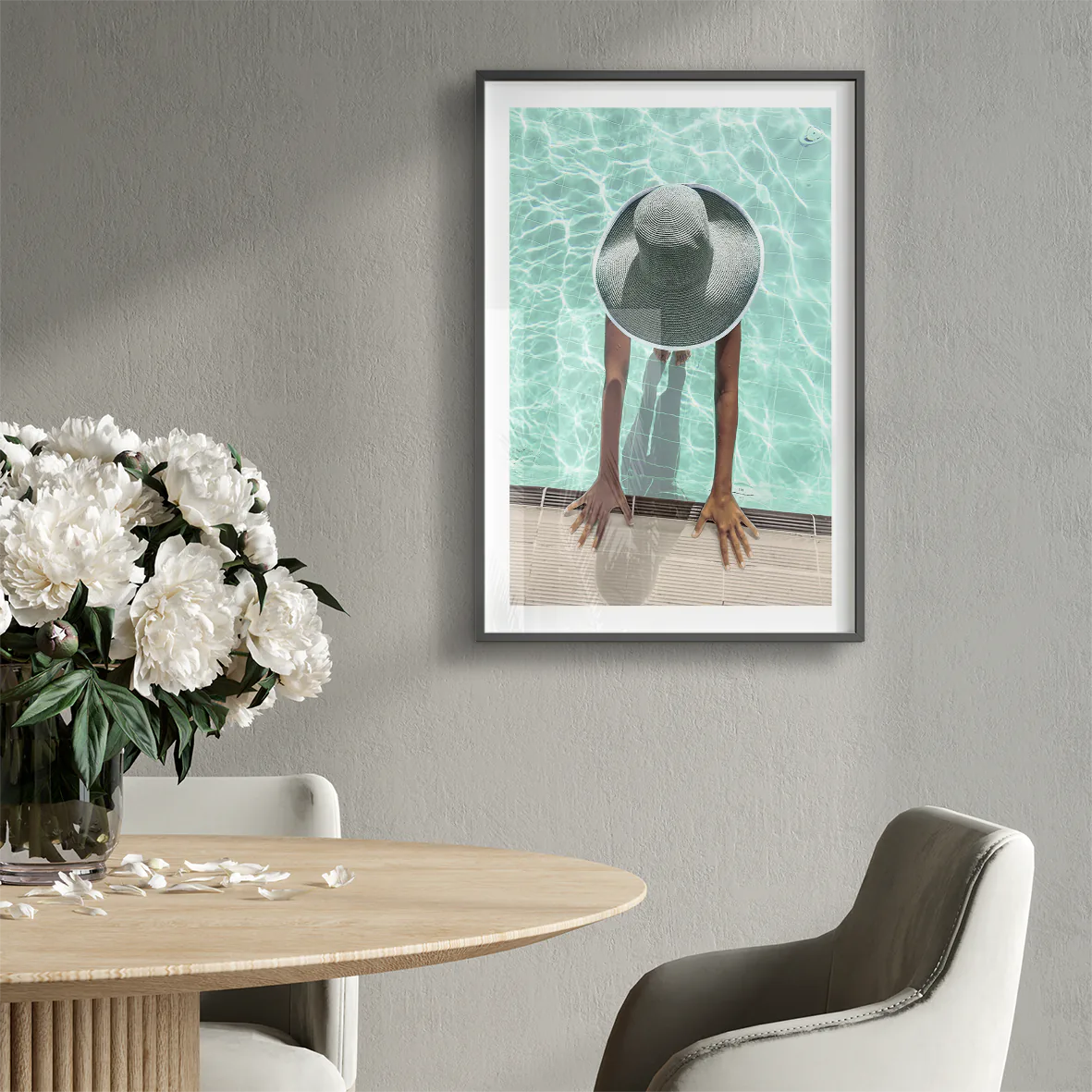 Elegant wall art showcasing a tranquil pool scene with a sunhat-clad figure,