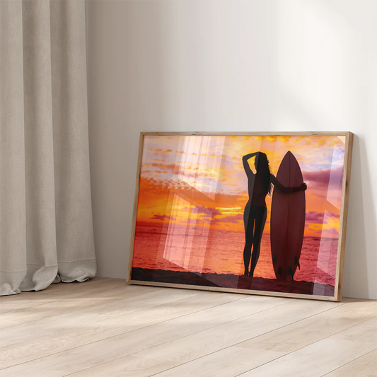 Breathtaking seaside sunset with female surfer holding a surfboard in a wall decor