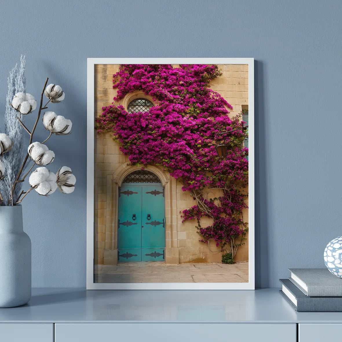 Turquoise door with vibrant purple flowers on a building facade