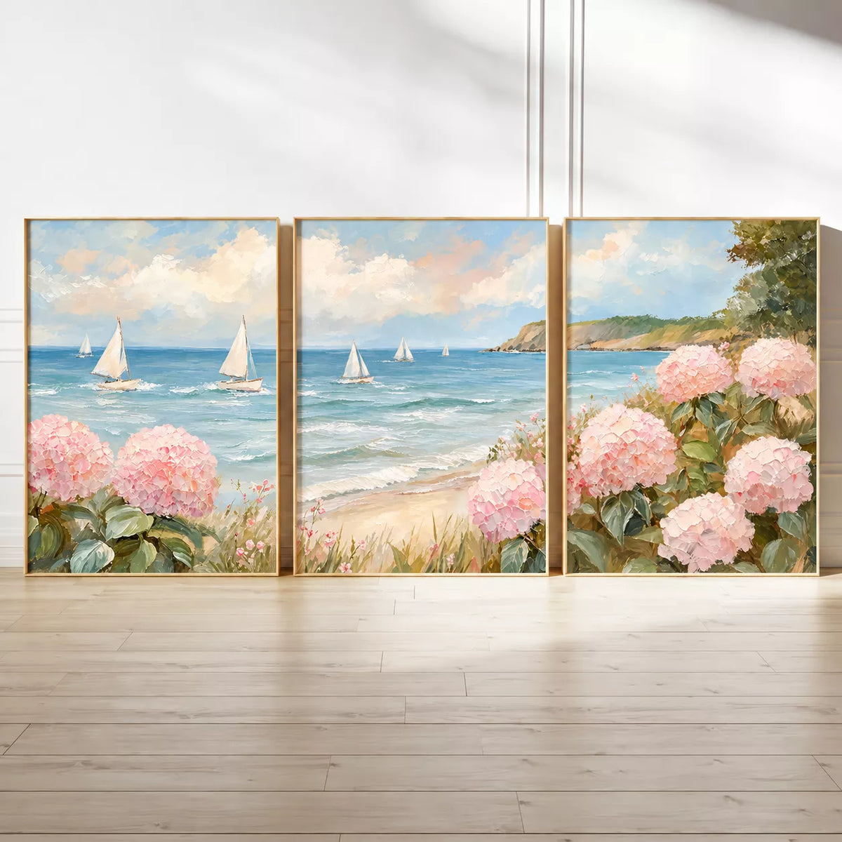 ピンクの紫陽花と青い海、白いヨットを油彩風に描いたポスター3枚を床に並べた全体イメージ